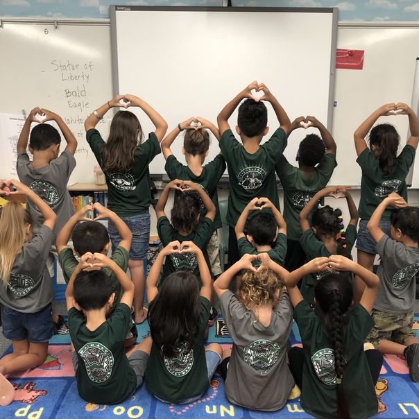 Students at Waimalu Elementary School making heart shapes for the Choose Love project